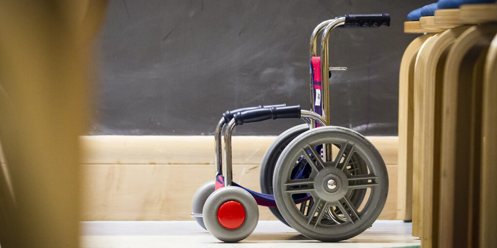 grey wheelchair beside chair
