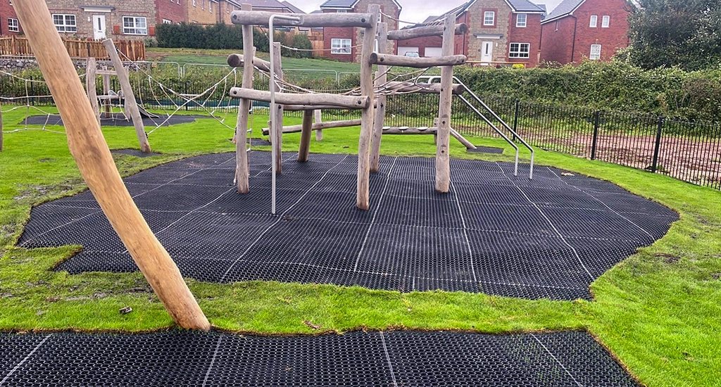 EcoSmart grass protector matting underneath wooden playground equipment